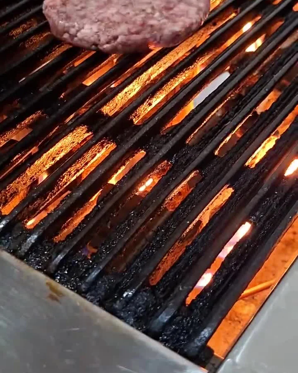 Beef cooking on the grill in Grüv's official Rare Bull reel