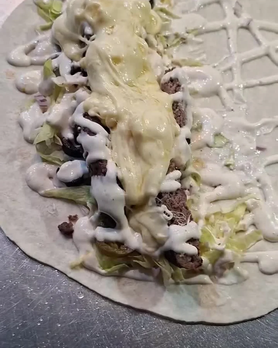 Grüv Rare Bull wrap prepared with beef and cheese, shown in the official reel